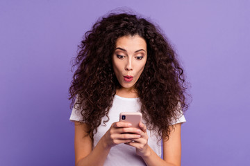 Close-up portrait of her she nice attractive lovely cheerful amazed wavy-haired lady holding in hand cellular buying online purchase app isolated on bright vivid shine violet pastel background