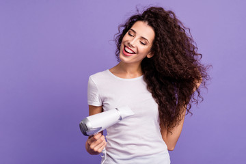 Portrait of her she nice-looking cute winsome lovely sweet attractive cheerful well-groomed wavy-haired lady drying strong healthy hair isolated on bright vivid shine violet pastel background