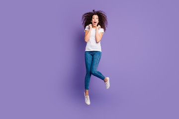 Full length body size photo beautiful she her lady cheerleader jump high ecstatic discount sale shopping wear casual jeans denim white t-shirt shoes sneakers isolated purple violet bright background