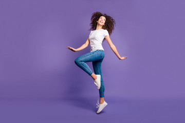 Fototapeta na wymiar Full length side profile body size photo beautiful amazing she her lady jump high spread hands arms cheerleader wear casual jeans denim white t-shirt sneakers isolated purple violet bright background
