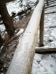 Snow cover the wooden bar.