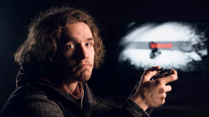 Man with sad expression is holding a Gamepad  