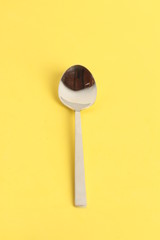 silver spoon isolated on colorful background