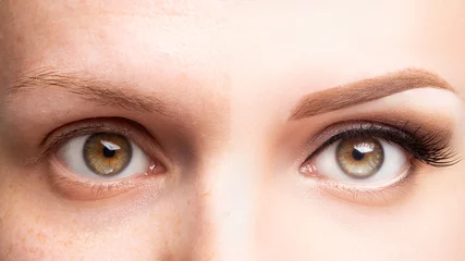 Fotobehang Female eyes before and after beautiful makeup, eyelash extension, eyebrow liner, microblading, cosmetology procedure, retouch © studiomay
