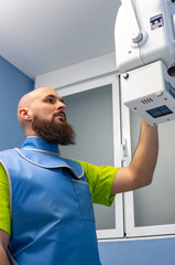Veterinarian using an x-ray device with lead clothing