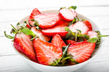 Fresh strawberries. Plate with juicy strawberry slices.
