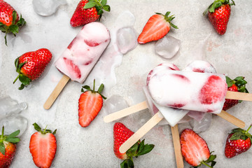 Homemade popsicles with strawberries, ice cream with milk and frozen fruits