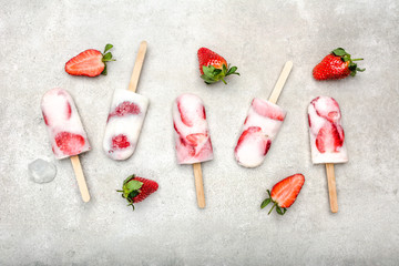 Fresh strawberry popsicles with yogurt and strawberries. Ice cream on sticks.