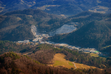 Fototapeta na wymiar Big stone quarry down in valley shot from top of the hill.