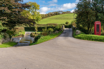 Stone bridge and a telephone booth in Malmsmead, Devon, England, UK