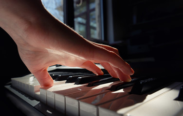 Fototapeta na wymiar Details of Hands playing piano