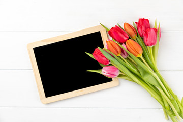 colorful tulips with chalkboard with copy space