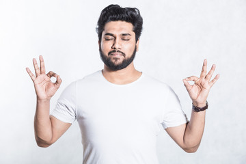 Handsome young man shows ok sign. Body language concept.