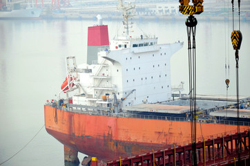 Cargo ship entering dry dock.