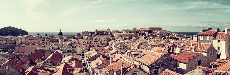 Dubrovnik Old City red tiled roofs, panoramic view from the ancient city wall, scenic cityscape. World famous and most visited historic city of Croatia, UNESCO World Heritage site, travel background