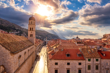 Fototapeta na wymiar Old City of Dubrovnik red roofs and Stradun main street, top view from ancient city wall. World famous and most visited historic city of Croatia, UNESCO World Heritage site, travel background