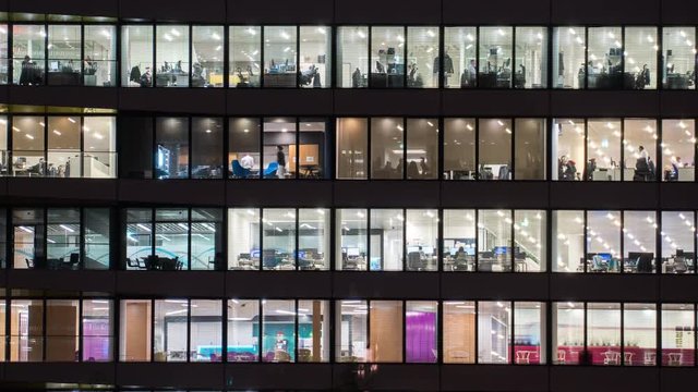 Evening time Close up View Office Windows Business Center London City UK Time lapse