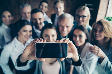 Close up blurry photo business people different age race free time excited team building hug embrace cuddle she her he him his telephone smart phone make take selfies  formal wear jackets shirts