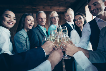 Close up photo business people diversity different age race team members holiday she her he him his company hold arms hands clink golden wine saying toasts congratulation formal wear jackets shirts