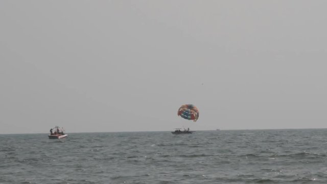 kitesurfing - water skiing with parachute in Arabian sea