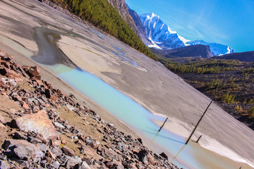 The dizzying landscape. The riverbed flowing from the snow-white mountains on the bottom of the...