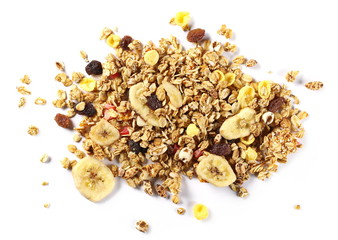 Crunchy tropical muesli pile mix with banana, pineapple, papaya slices and raisins isolated on white background