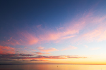 Fototapeta na wymiar Ocean, sunset , beach , sky ,clouds, twilight, blue, pink, orange, sand,