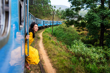 Woman sitting by the train door Sri Lanka