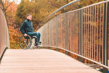Man in a wheelchair use a wheelchair ramp.