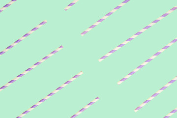 Purple paper straws on mint green background
