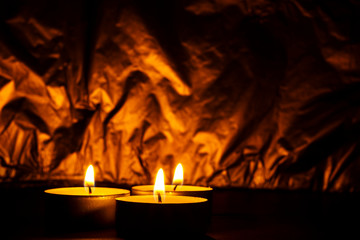 candles burned in the dark, gleaming