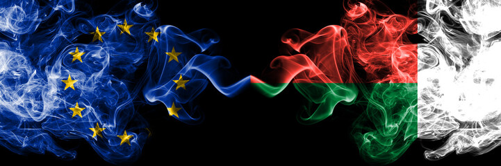 European Union vs Madagascar, Madagascan smoke flags placed side by side. Thick colored silky smoke flags of EU and Madagascar, Madagascan