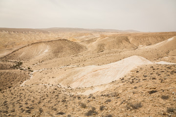 Fototapeta na wymiar Scenic view of sand, hills and rocks in Negev Desert in Mitzpe Ramon