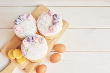 Easter cakes, eggs and macaroons on the table