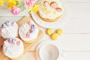 Easter cake with gingerbread on the table, the table is decorated with flowers, macaroons  and eggs