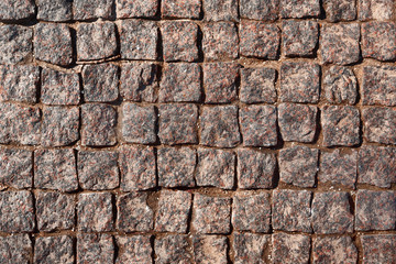 Background of granite paving stones. View from above.