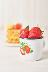 strawberries in a cup on a white background