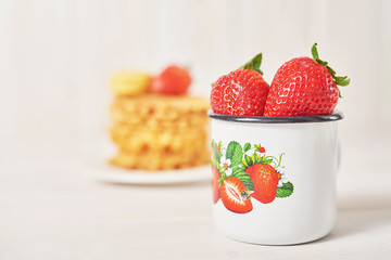 strawberries in a cup on a white background