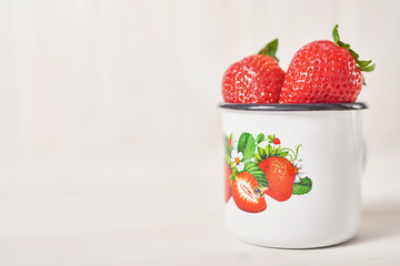 strawberries in a cup on a white background