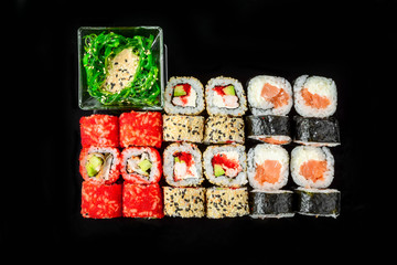 traditional fresh japanese sushi rolls on a black background
