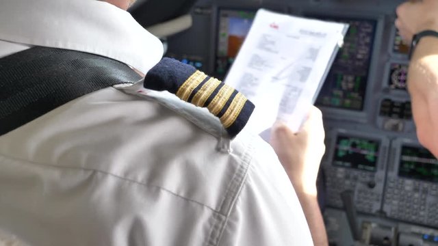 Airline Pilots in Uniform, Close Up Cockpit Flight Checklist, 4K.