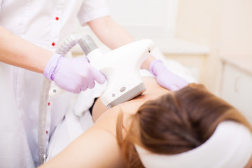 Body Care. Woman is in the process at the clinic lipomassage