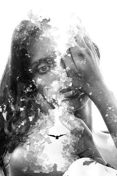 Paintography. Double Exposure portrait of a young beautiful woman combined with hand drawn ink painting with a flying bird. Black and white