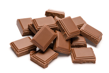 Milk organic chocolate pieces isolated on white background