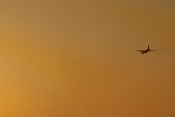 the plane flies high in the sky and the sun