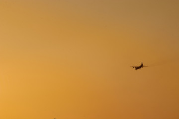 the plane flies high in the sky and the sun