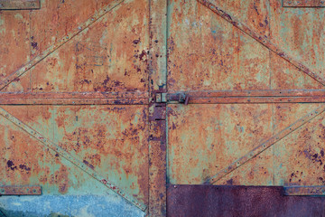 Textured background cracked green paint on an old rusty metal surface, a fragment of the gate.