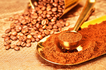 Coffee beans, golden cup of coffee on a brown background.