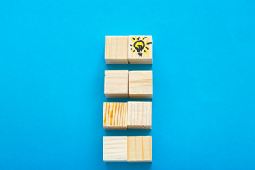 Success concept, stairs of wooden cubes on the blue backgound.