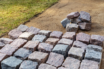 garden path construction - laying granite stone pavers at home backyard